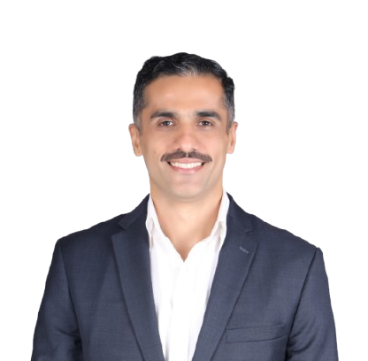 Portrait of a smiling man in a navy blazer and white shirt, looking at the camera on a plain background.